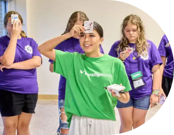 girl in green shirt playing a game at a Paradigm Shift event